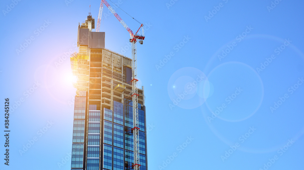 High-rise building under construction. Modern office building. Sunset.