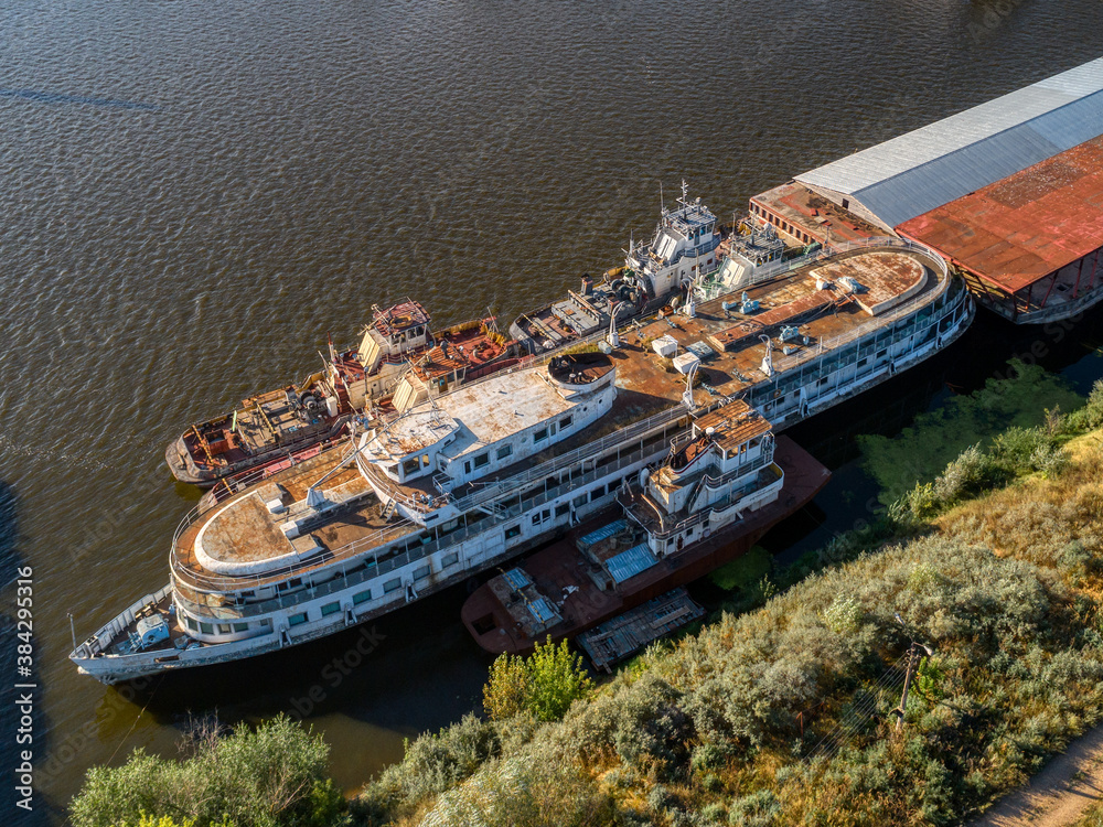 Cargo barges are parked at the pier. River cargo fleet,