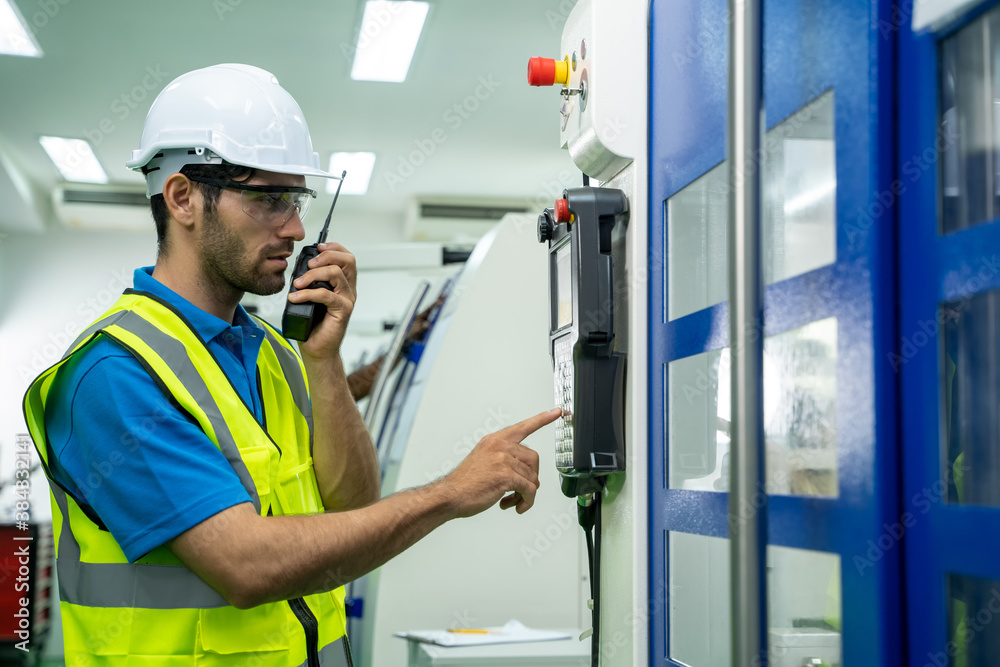 Factory engineers use radio to communicate in industrial factory.