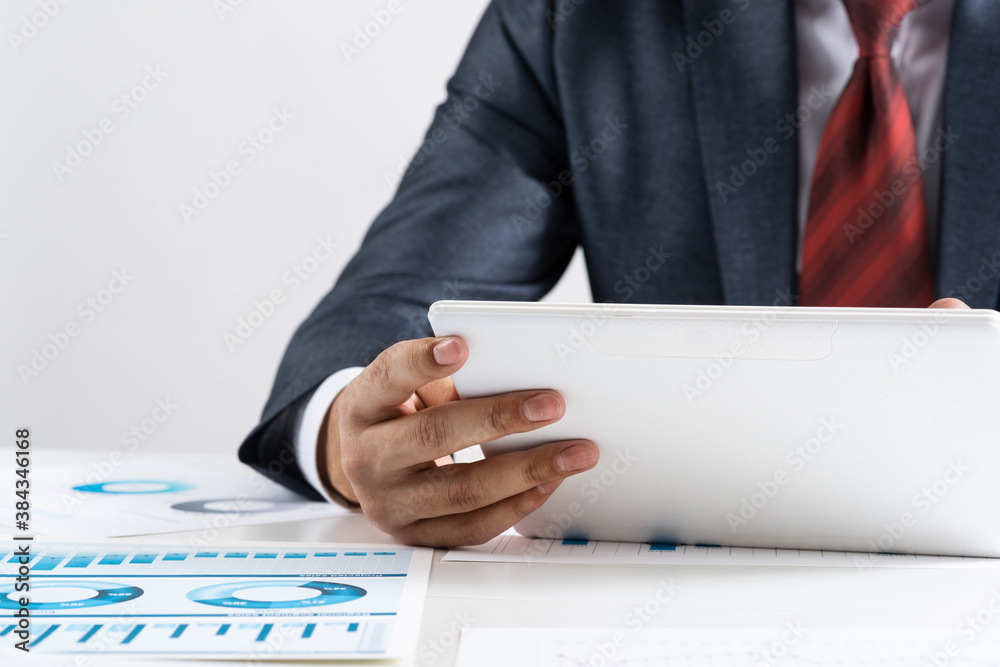 Businessman using tablet computer at office desk