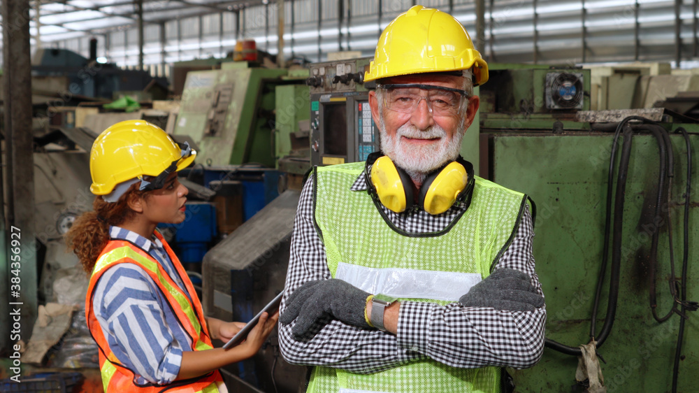 Senior factory worker or engineer close up portrait in factory . Industry and engineering concept .