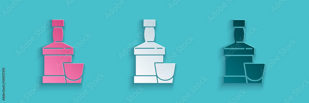 Paper cut Whiskey bottle and glass icon isolated on blue background. Paper art style. Vector.