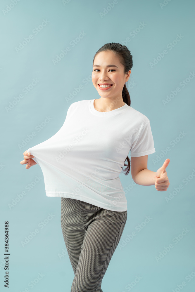 Successful weight loss, woman with too large t-shirt after a diet