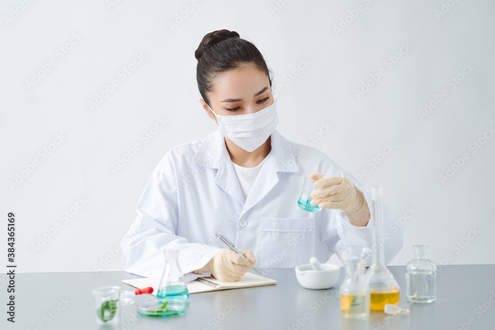 doctor woman scientist making herbal medicine in lab with herb leaves vitamin supplements mineral al