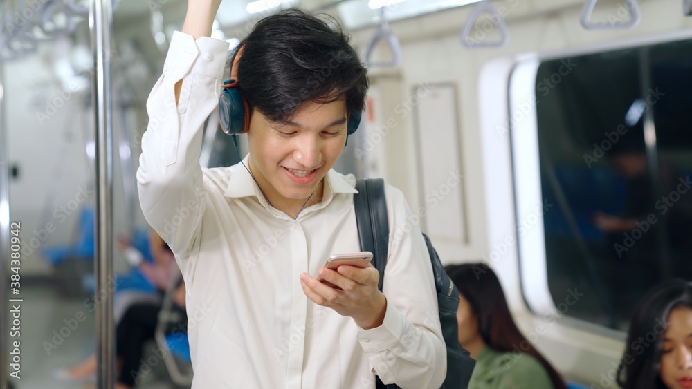 Businessman using mobile phone on public train . Urban city lifestyle commuting concept .