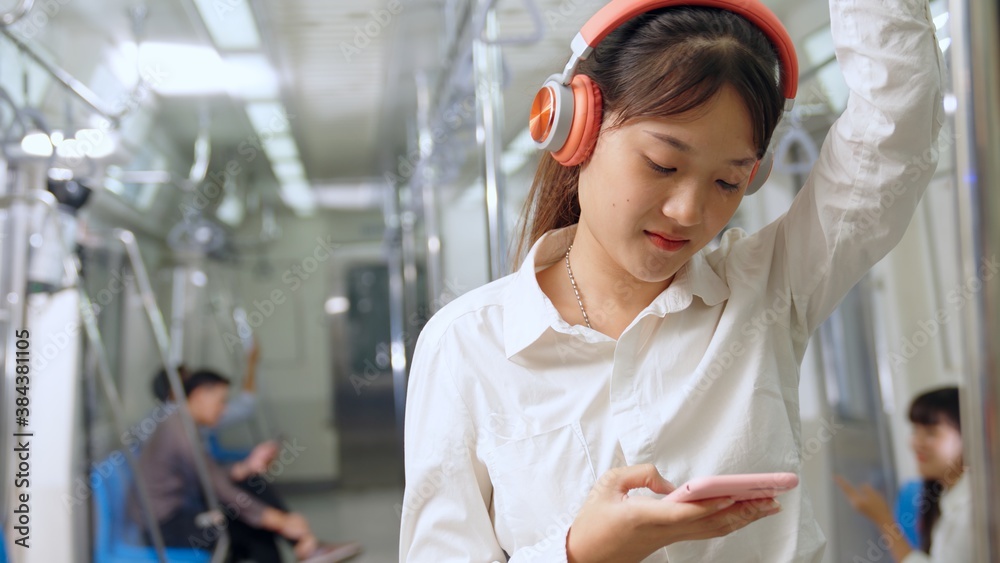 Young woman mobile phone on public train . Urban city lifestyle commuting concept .