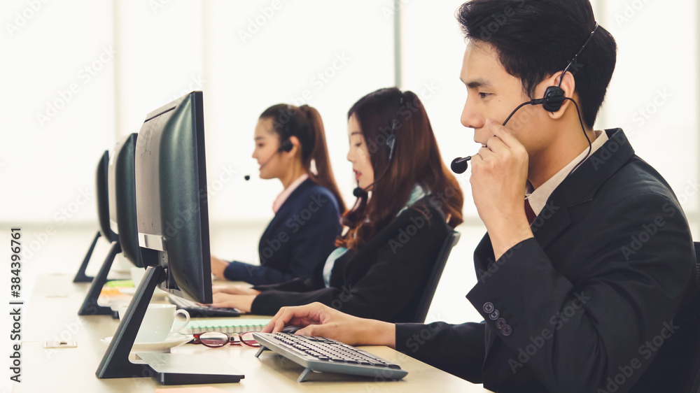 Business people wearing headset working in office to support remote customer or colleague. Call cent