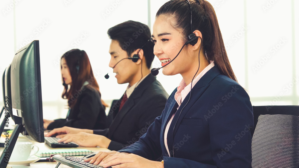 Business people wearing headset working in office to support remote customer or colleague. Call cent