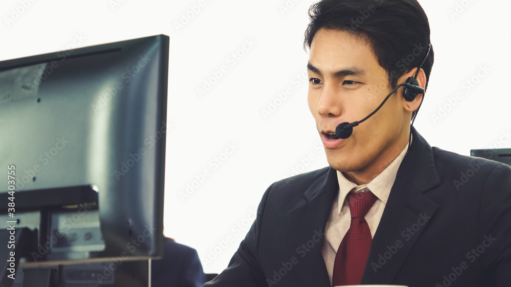 Business people wearing headset working in office to support remote customer or colleague. Call cent