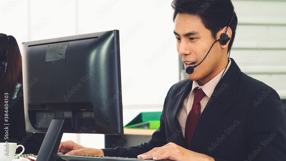 Business people wearing headset working in office to support remote customer or colleague. Call cent