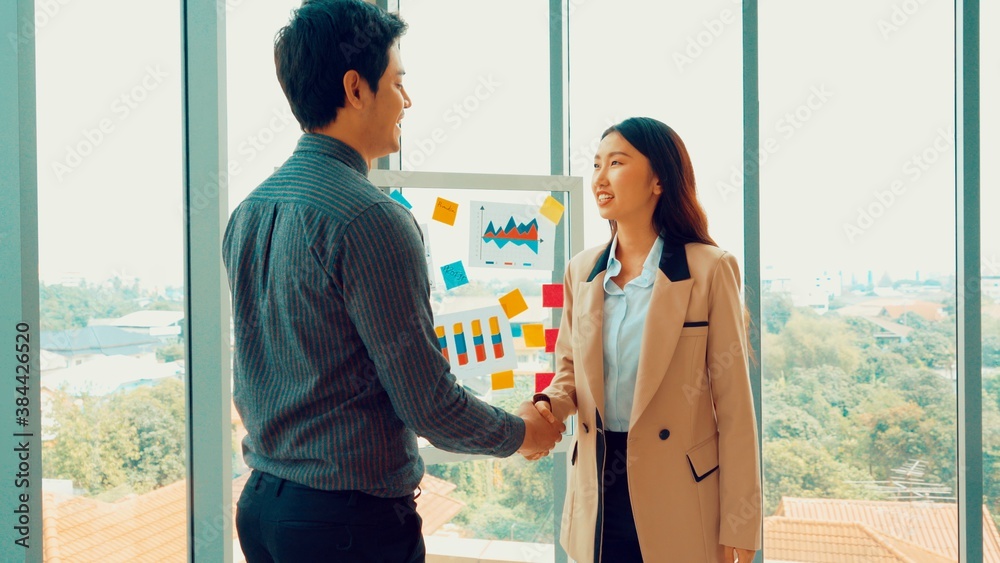 Business people handshake in corporate office showing professional agreement on a financial deal con