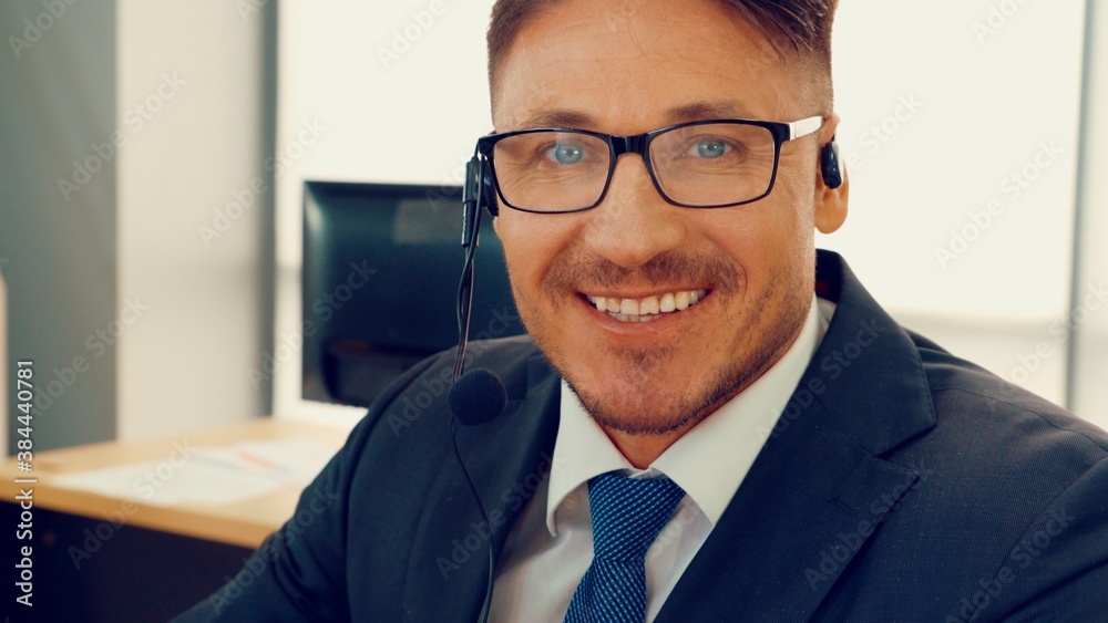 Business people wearing headset working in office to support remote customer or colleague. Call cent