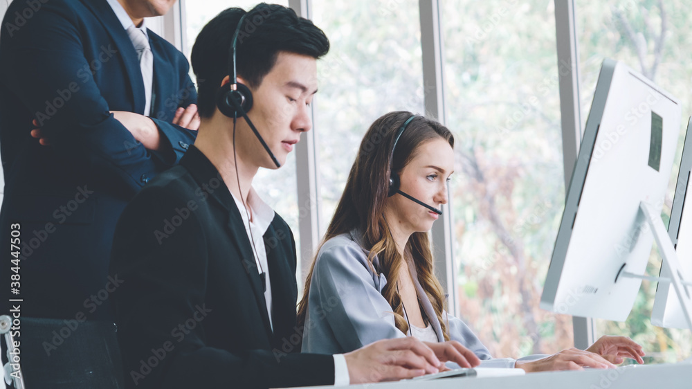 Business people wearing headset working in office to support remote customer or colleague. Call cent