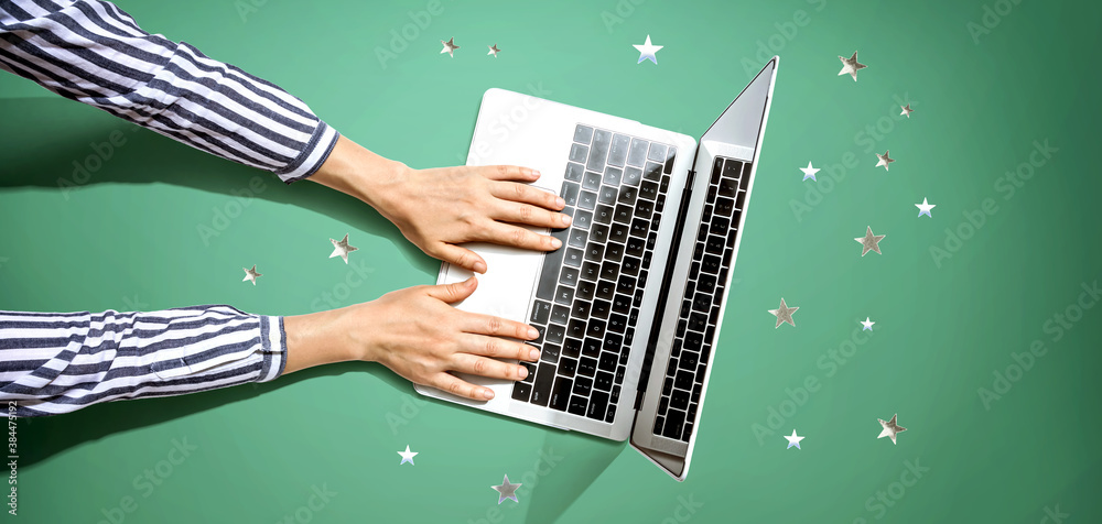 Person using a laptop computer with small stars from above