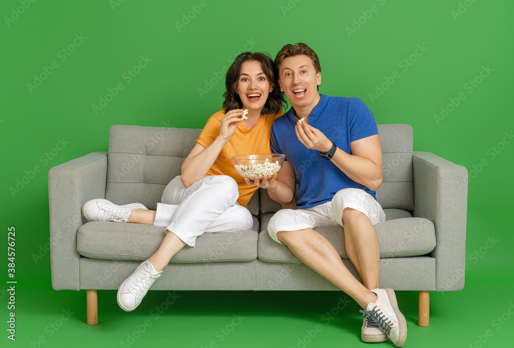 Happy couple on bright color background.