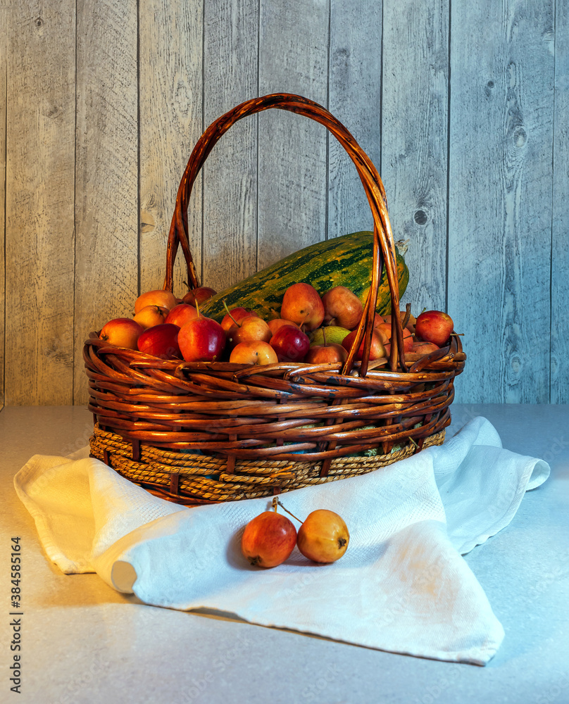 Crabapples and a squash lie in the basket.