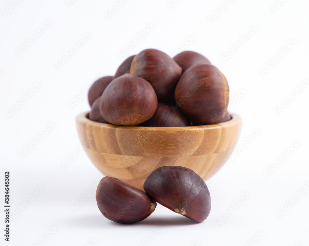 Fresh Chestnuts fruit isolated in wooden bowl on white background