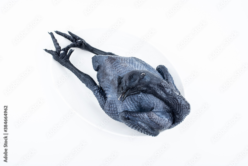 A fresh black chicken on white background