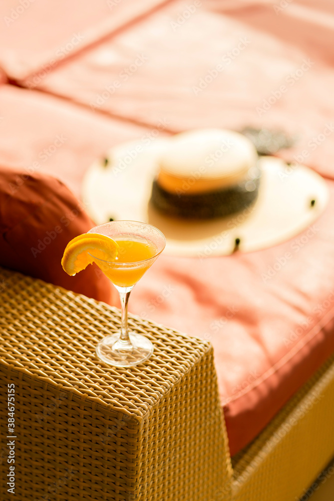 orange cocktail glasses on rattan bench at wooden cruise deck summer vacation moment relax and peace