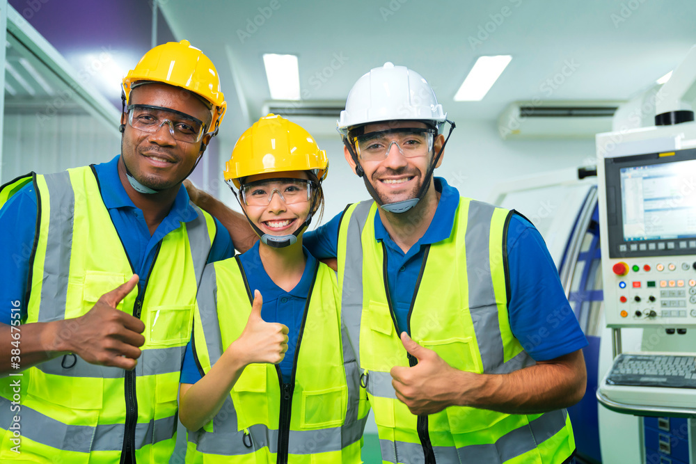 Close up portrait team of young multiethnic group male and female technician staff wearing a protect