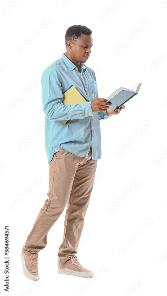 African-American man with books on white background