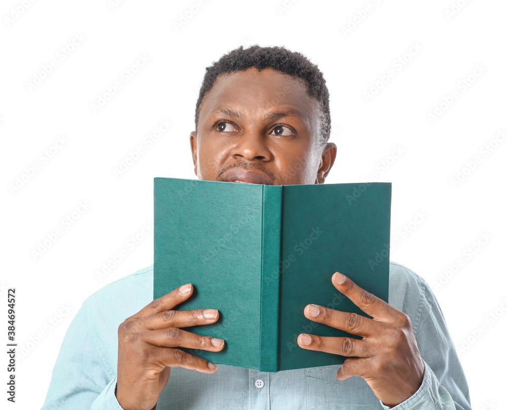 African-American man reading book on white background