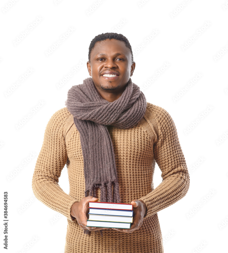 African-American man with books on white background