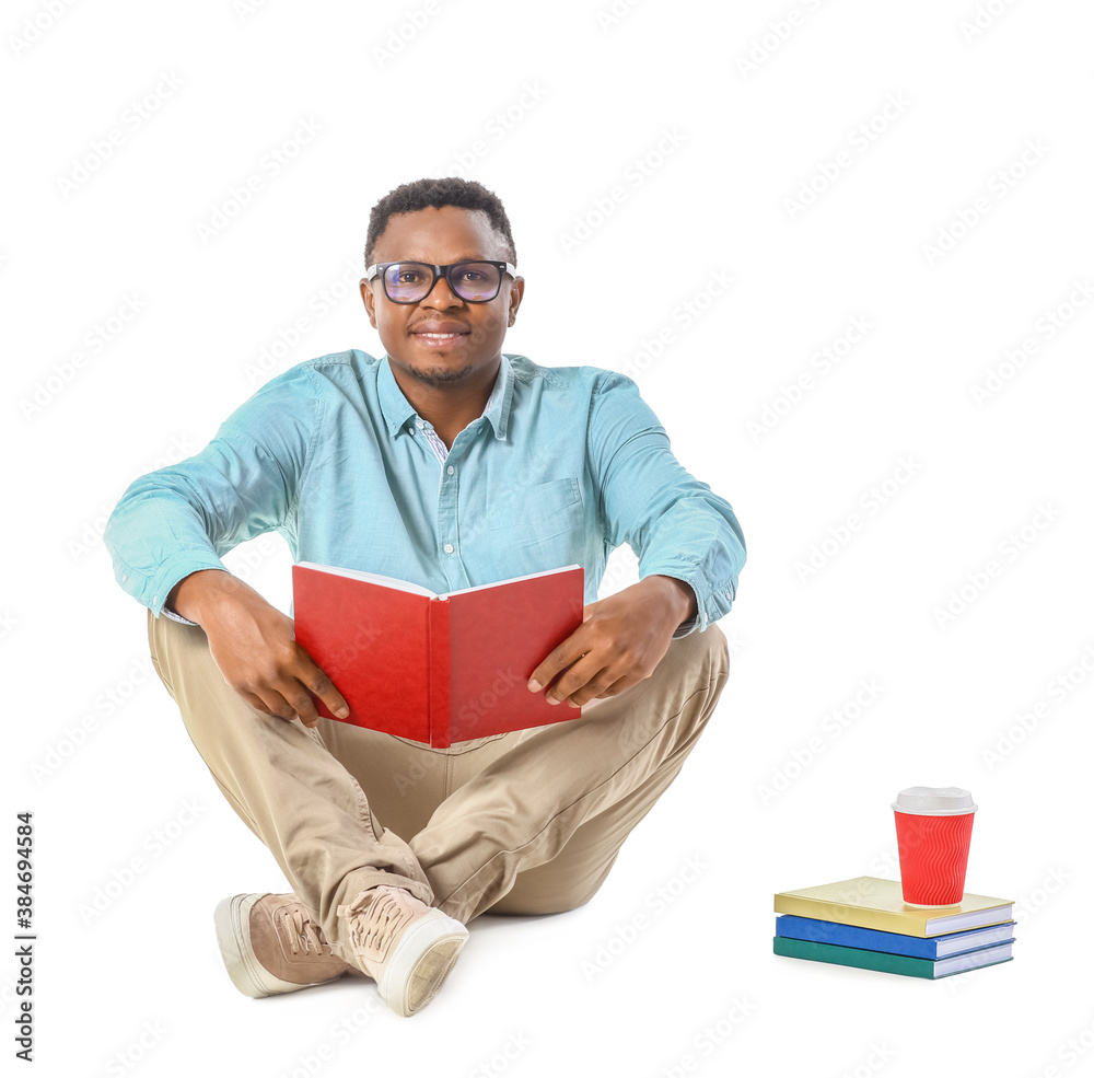 African-American man reading book on white background