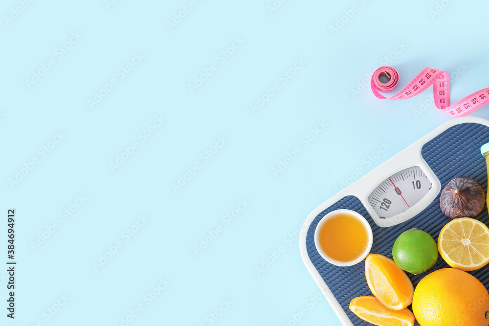 Fresh products, scales and measuring tape on color background. Diet concept