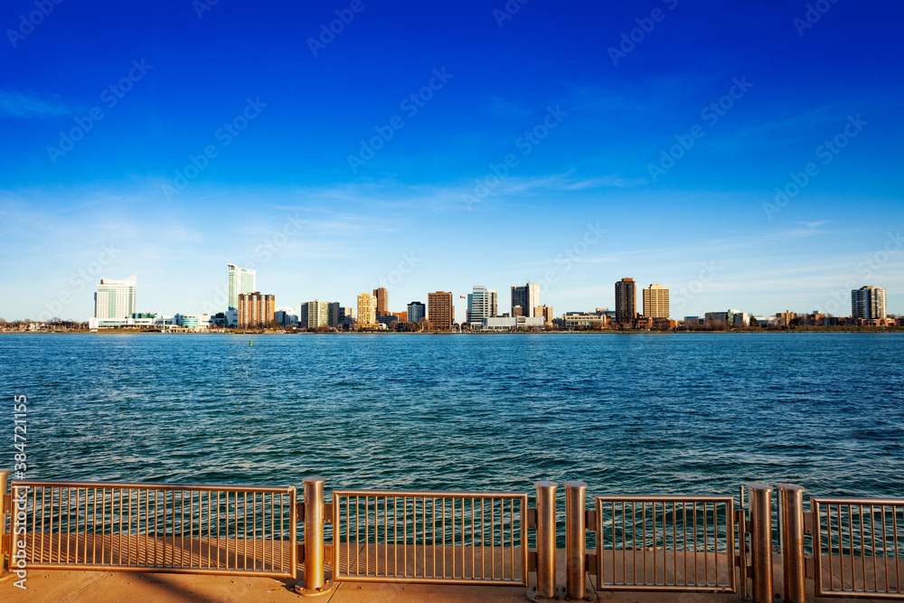 Detroit, Michigan USA Riverwalk and view on Windsor, Ontario, Canada with rails fence