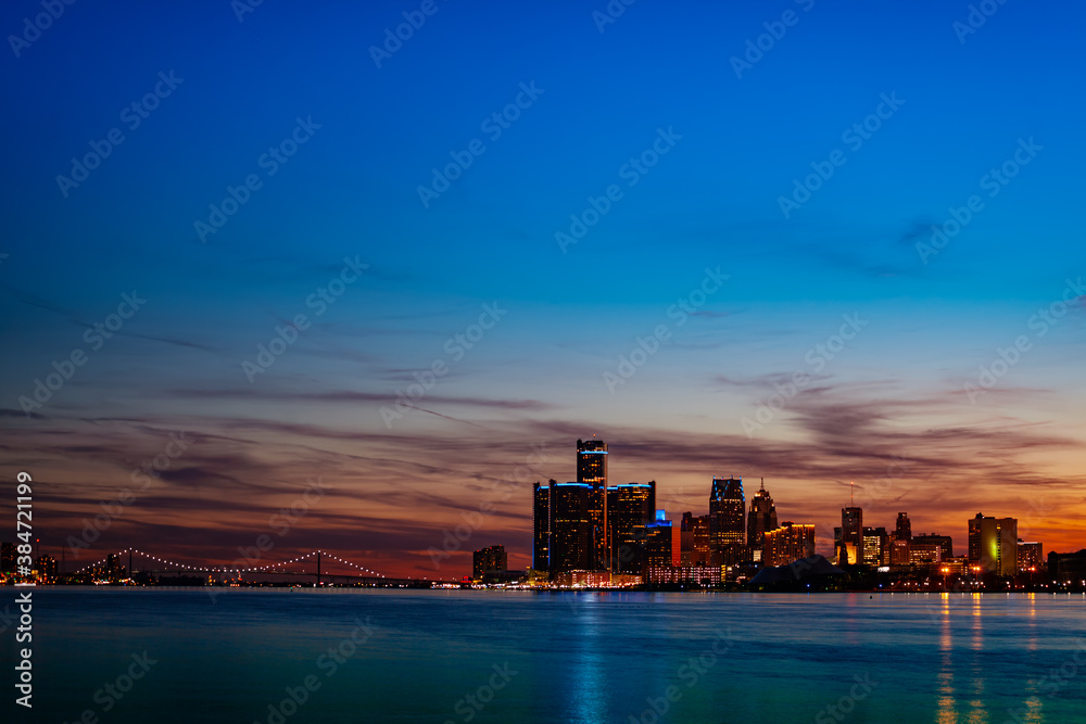 Night view of Detroit downtown skyscrapers and river from sunset point of Belle Isle, Michigan USA