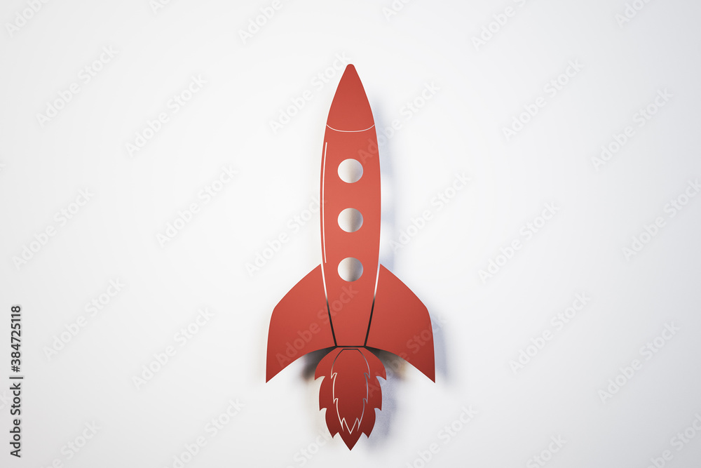 Toy red rocket on white background.