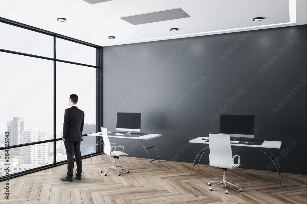 Businessman standing in office interior w