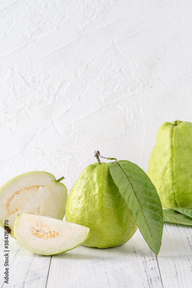 Delicious guava fruit set on white wooden table background with copy space.