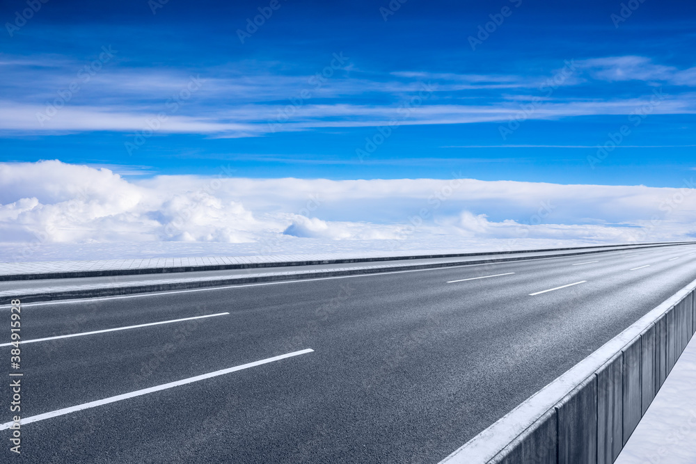 Empty asphalt road and blue sky with white clouds scenery.