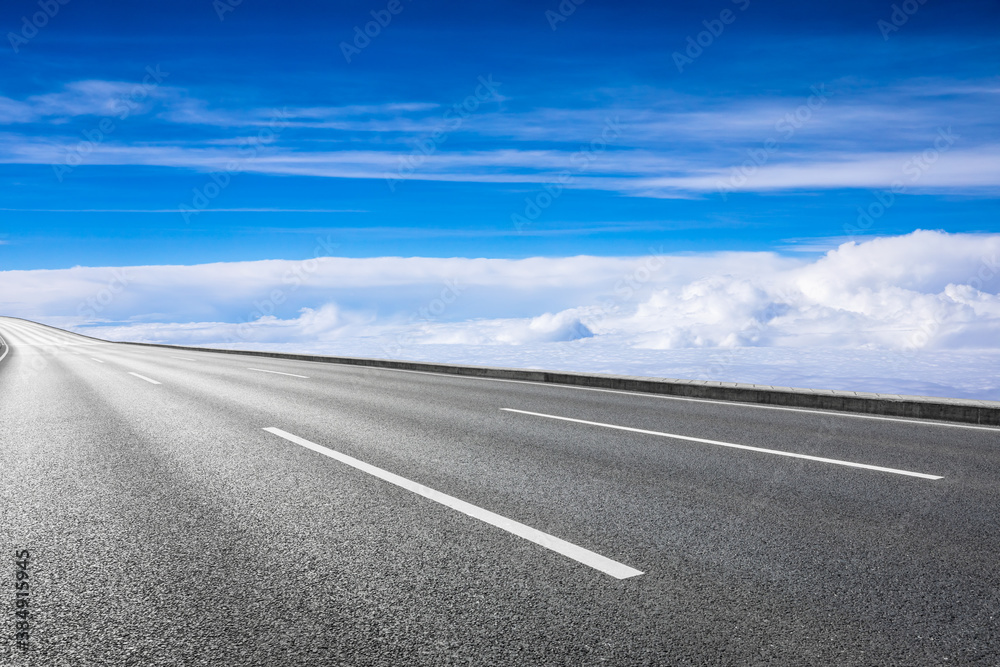 Empty asphalt road and blue sky with white clouds scenery.