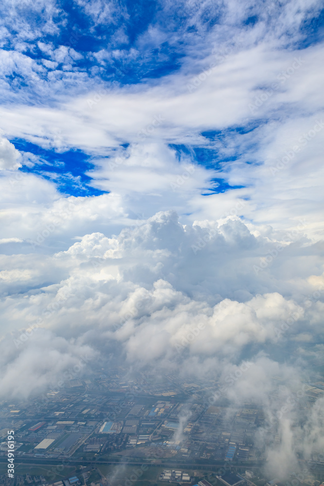 Aerial view above the clouds and mountain peaks on a sunny day.mountain view from airplane.