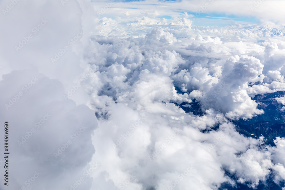 Aerial view above the clouds and mountain peaks on a sunny day.mountain view from airplane.