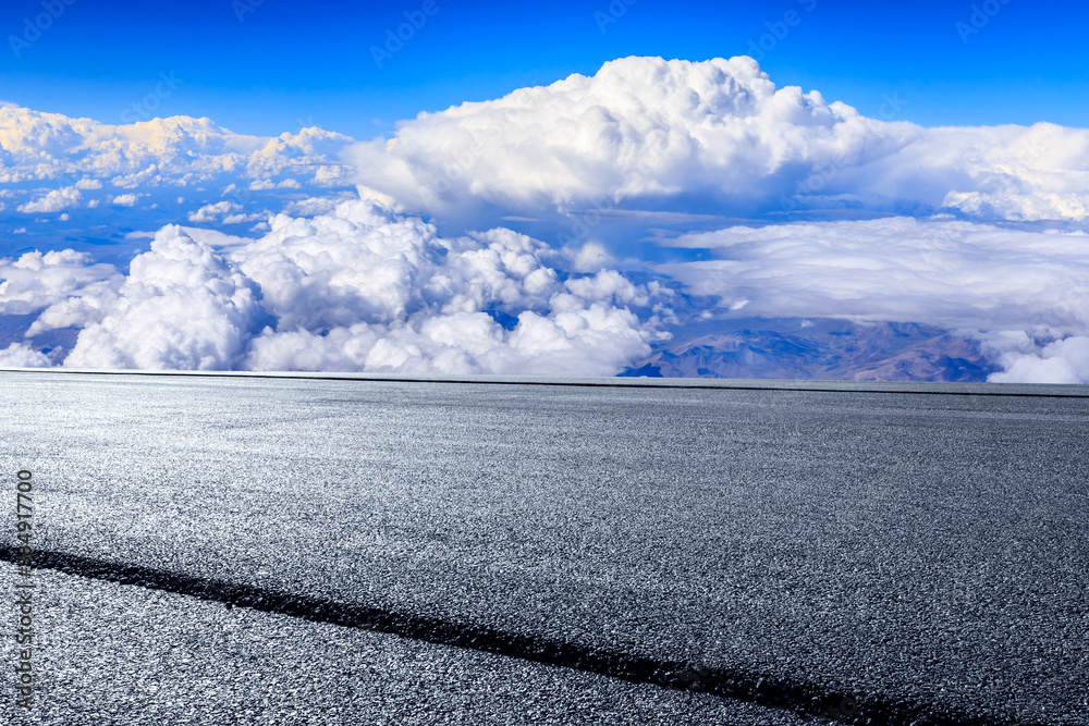 Empty asphalt road and blue sky with white clouds scenery.