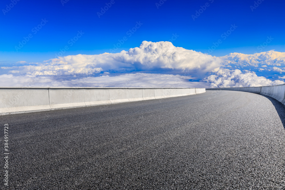 Empty asphalt road and blue sky with white clouds scenery.