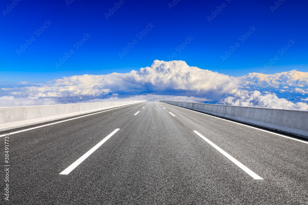 Empty asphalt road and blue sky with white clouds scenery.