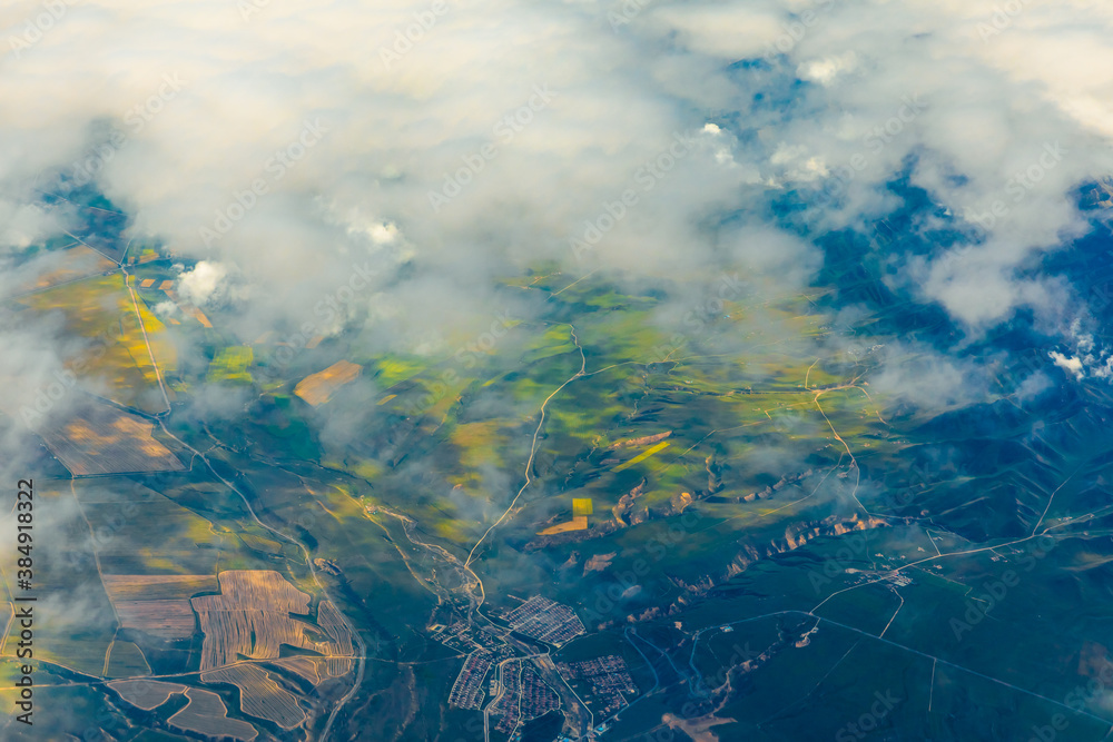 Aerial view above the clouds and mountain peaks on a sunny day.mountain view from airplane.