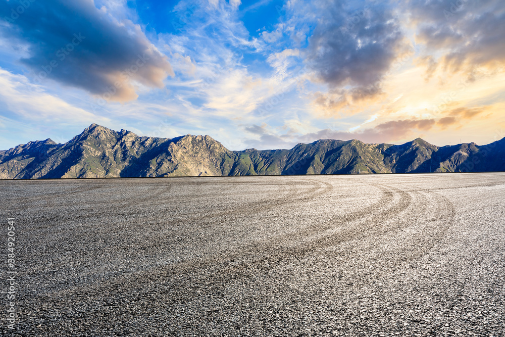 Asphalt road and mountain with sky clouds landscape at sunrise.