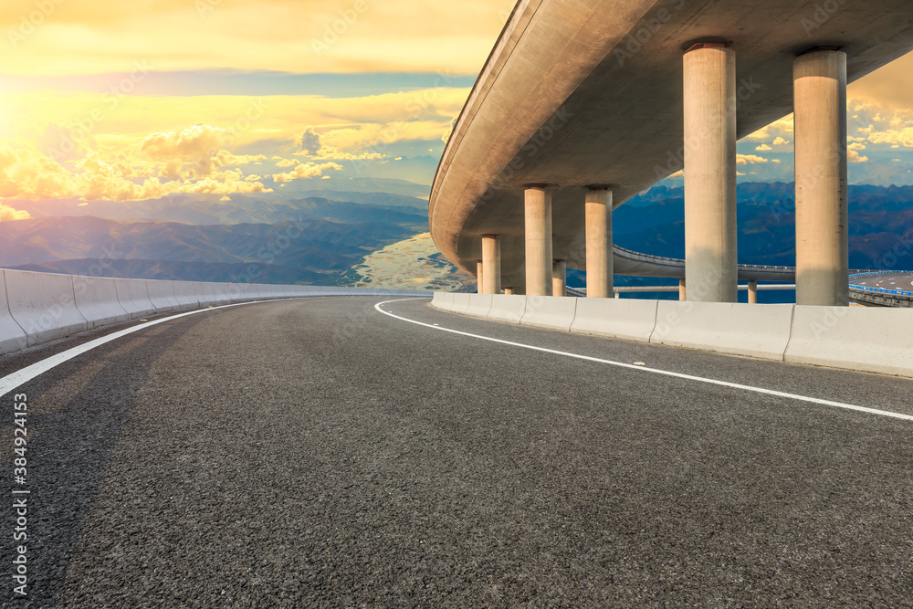 Empty asphalt road and Bridge with mountain scenery.