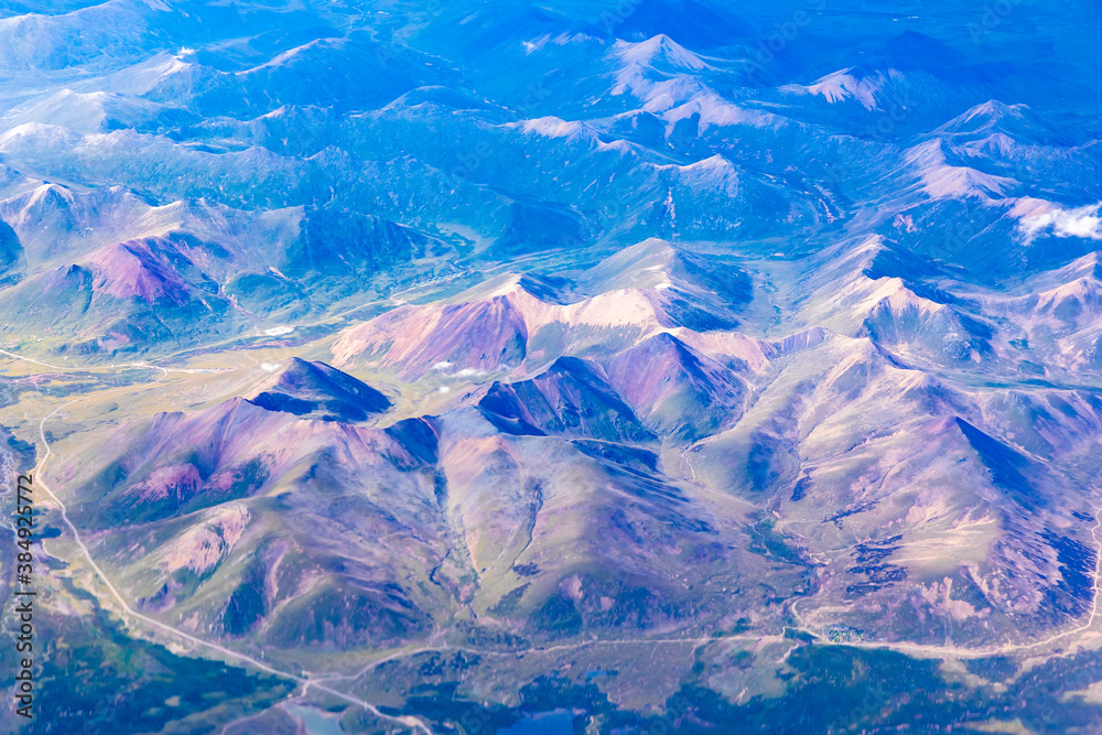 Aerial view above the clouds and colorful mountain on a sunny day.mountain view from airplane.