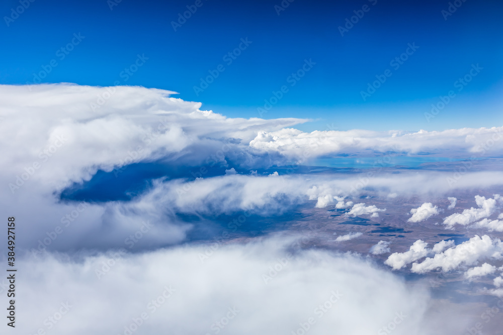 Aerial view above the clouds and mountain peaks on a sunny day.mountain view from airplane.