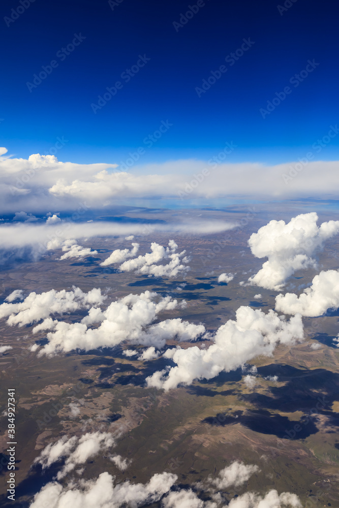 Aerial view above the clouds and mountain peaks on a sunny day.mountain view from airplane.