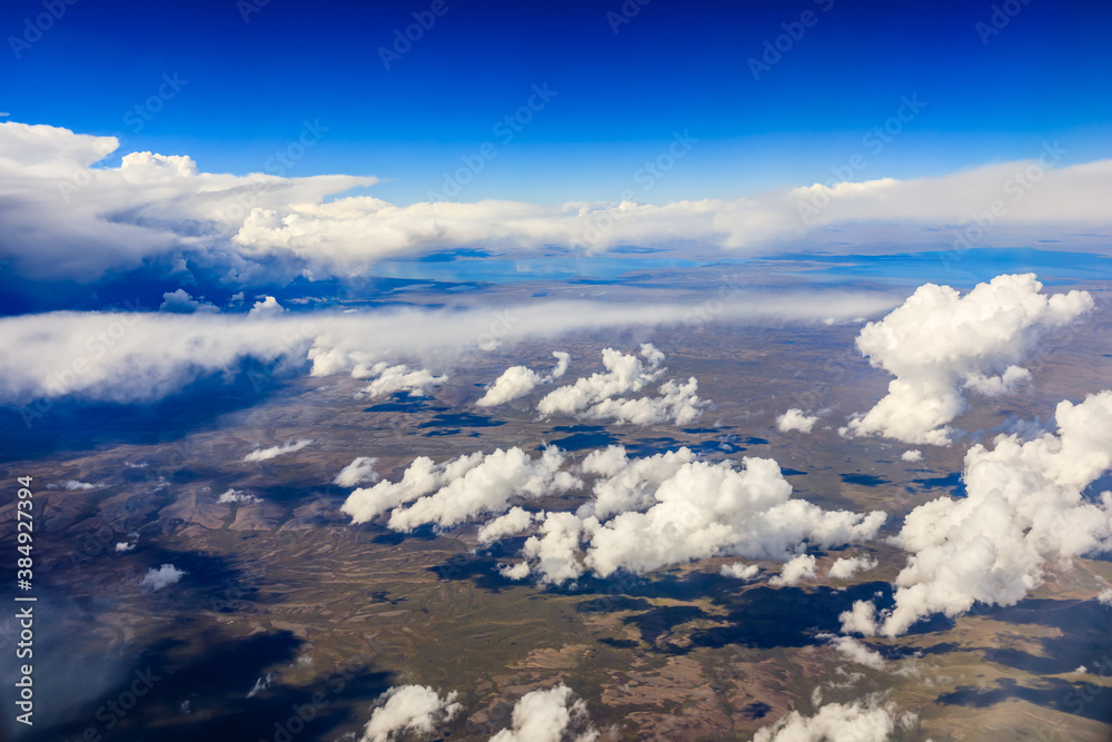 Aerial view above the clouds and mountain peaks on a sunny day.mountain view from airplane.