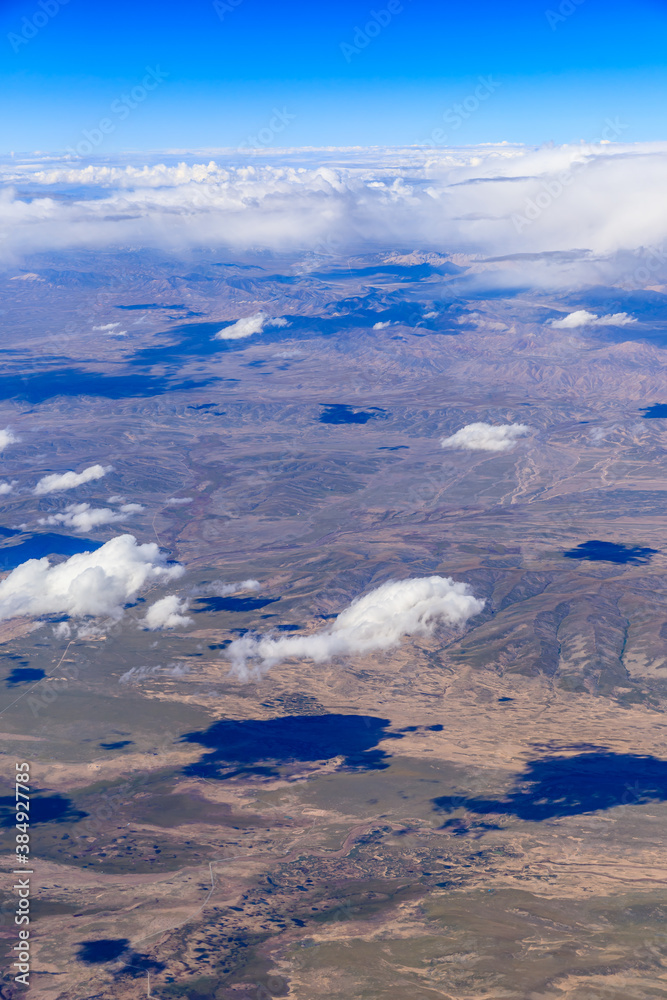 Aerial view above the clouds and mountain peaks on a sunny day.mountain view from airplane.