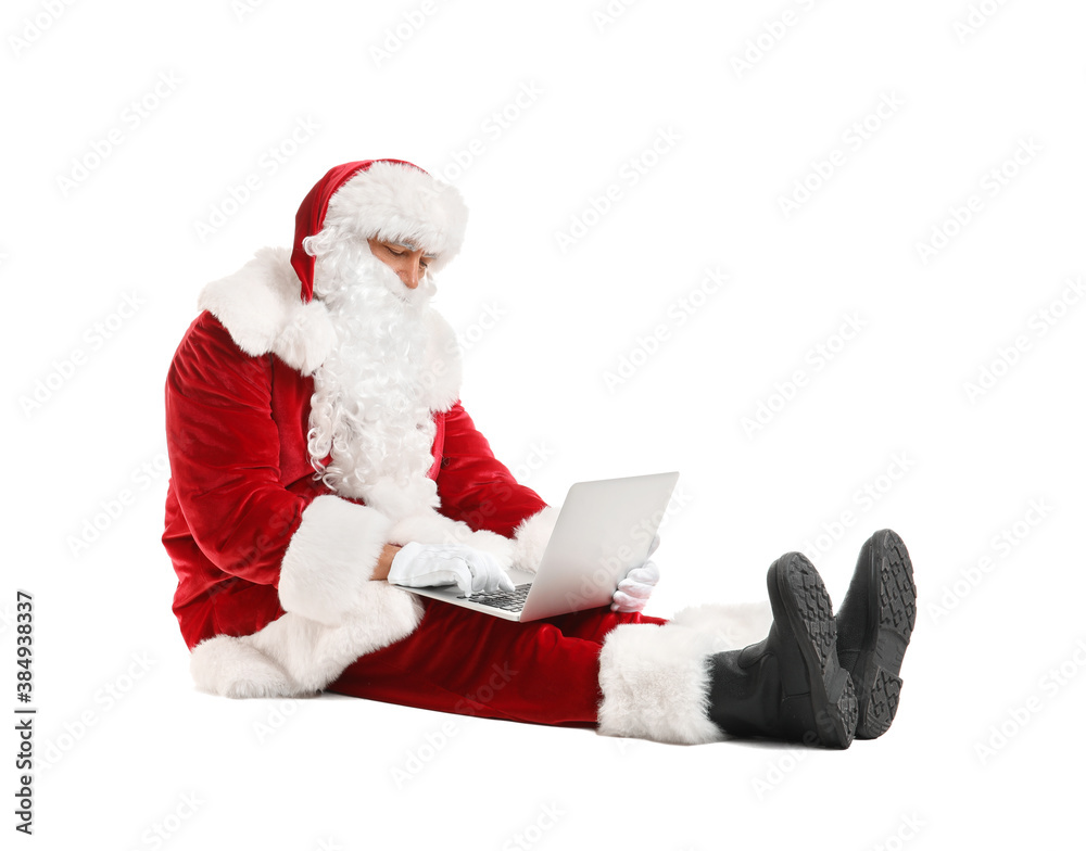 Santa Claus with laptop checking e-mail on white background